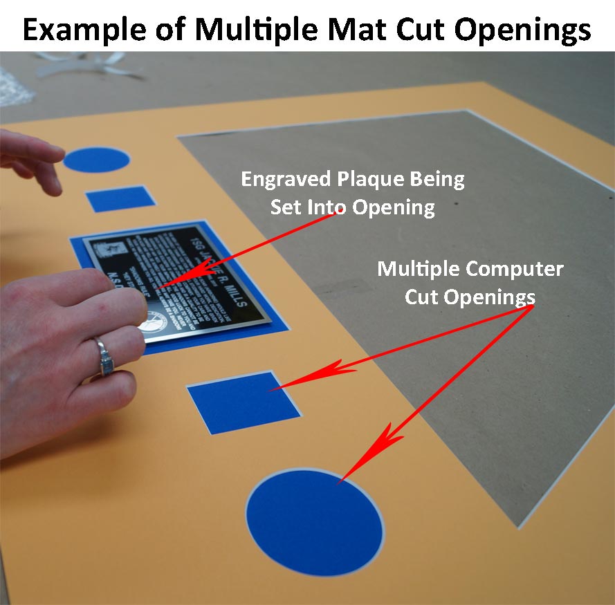 Example of Computer mat cut with a plaque being placed into one of the openings